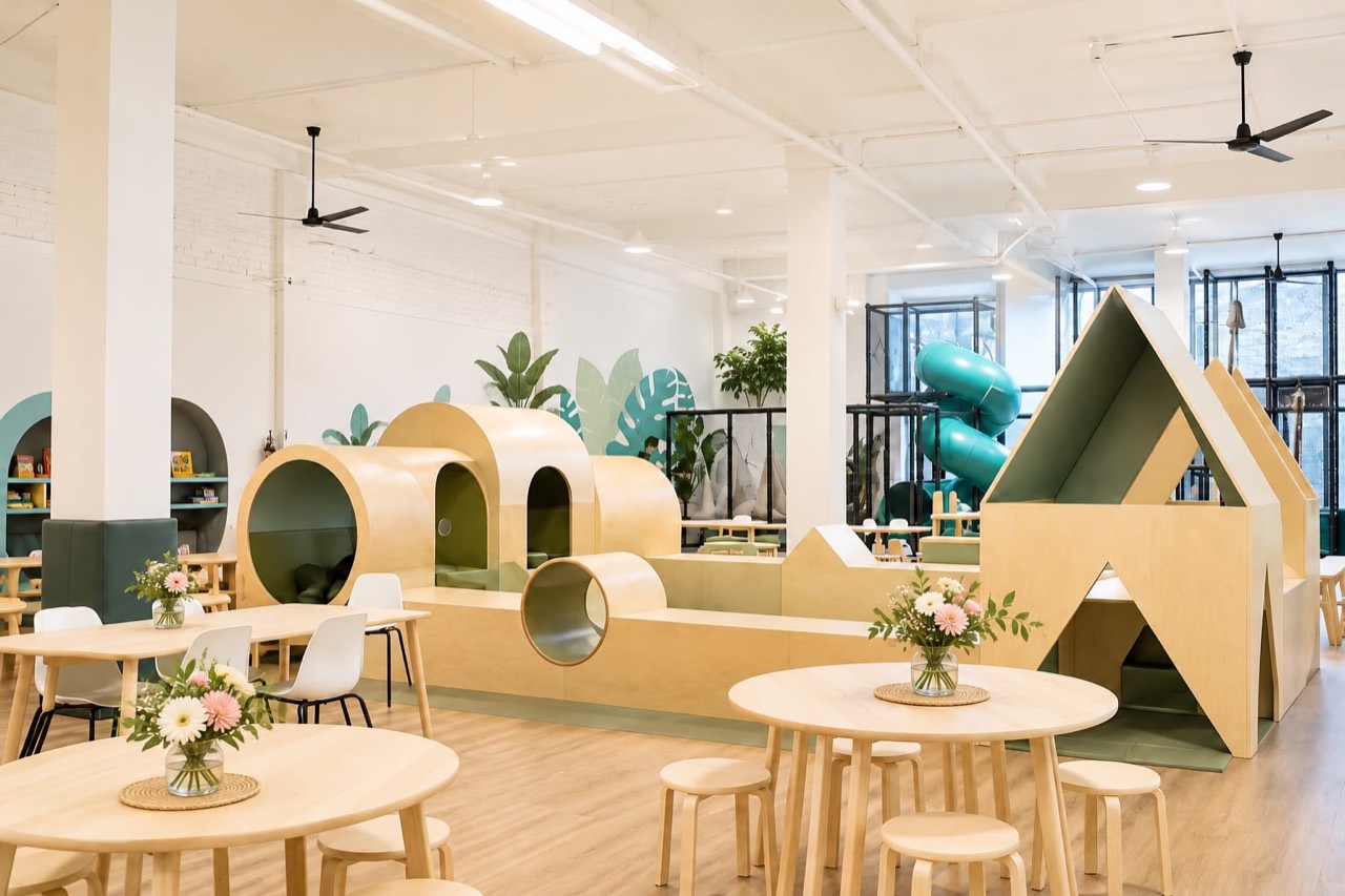 Bright Play Nook venue with café tables and wooden play structures